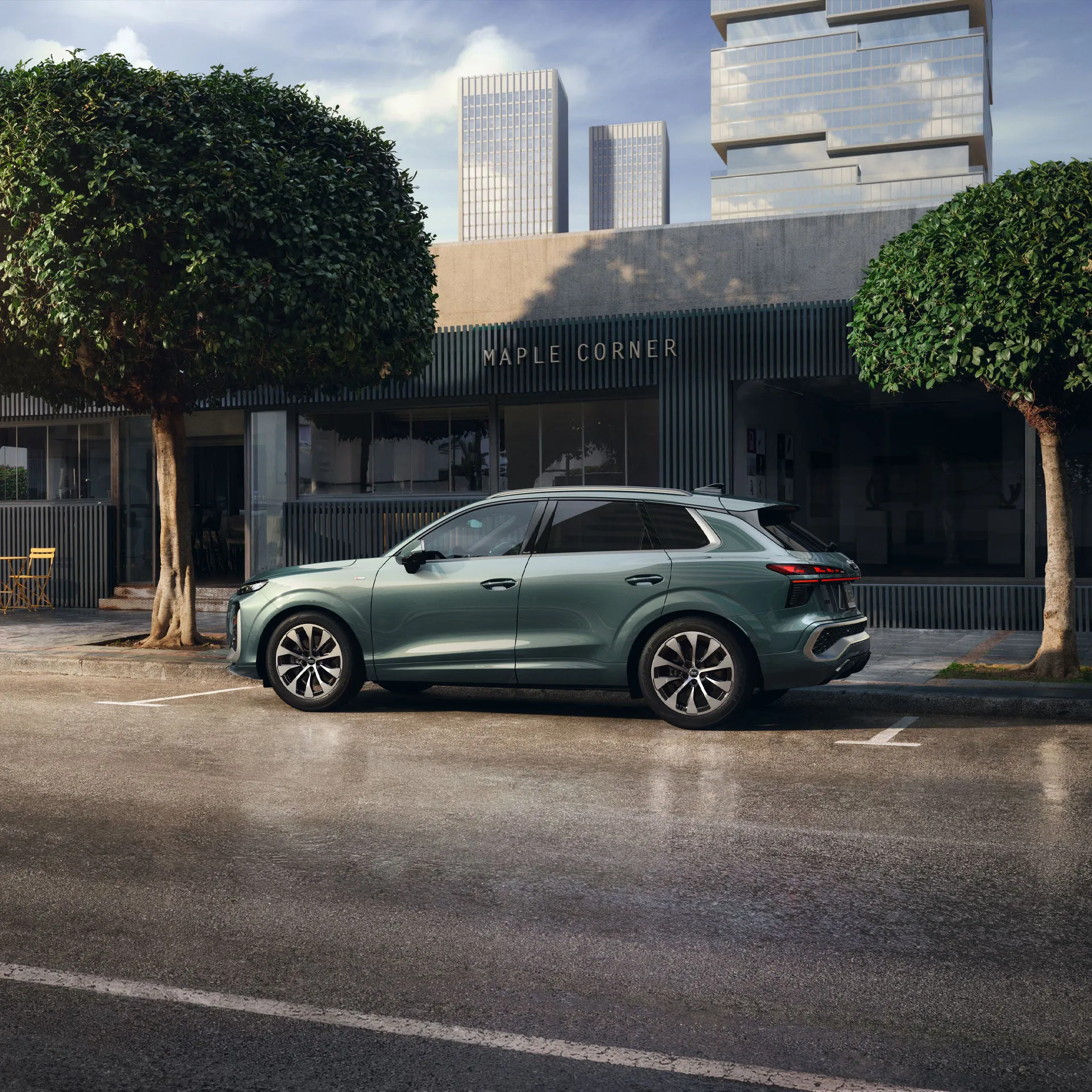 Side view of the Audi 2026 Q3 parked on a city street.