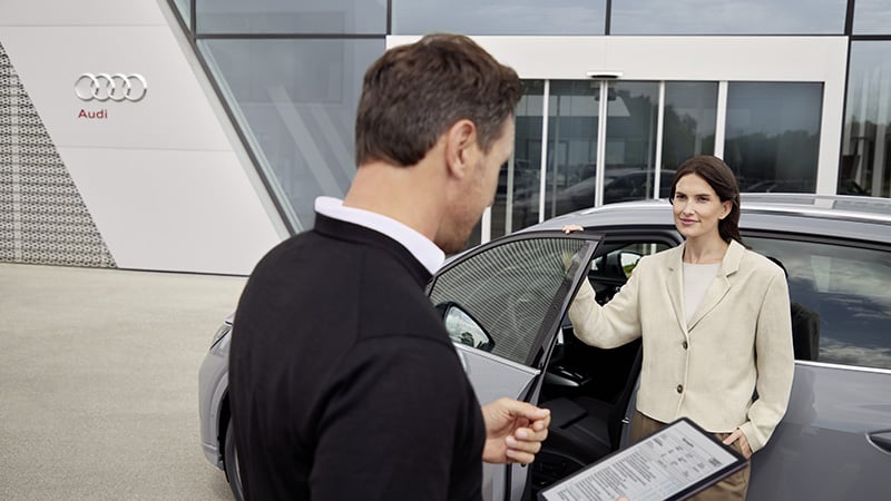 Audi Technician handing lady the key to her Audi