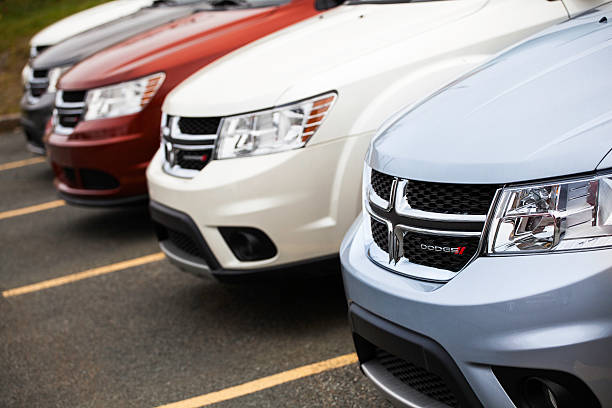 Dartmouth, Nova Scotia, Canada - October 28, 2012: Various colors of Dodge Journey vehicles in a row at a car dealership. Vehicles sit in parking spaces and are separated by solid line.