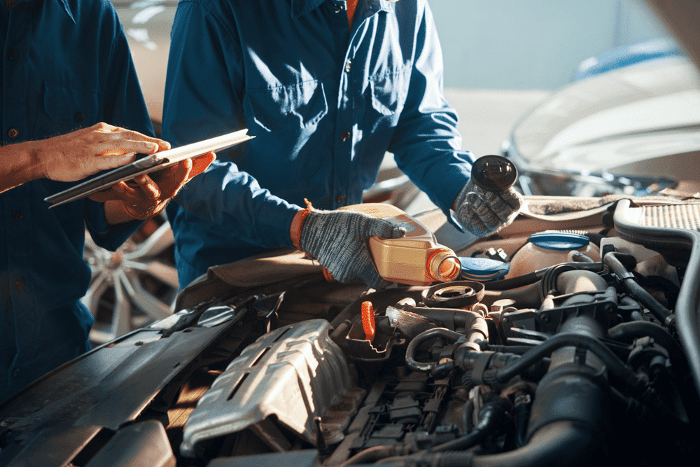 mechanics changing oil