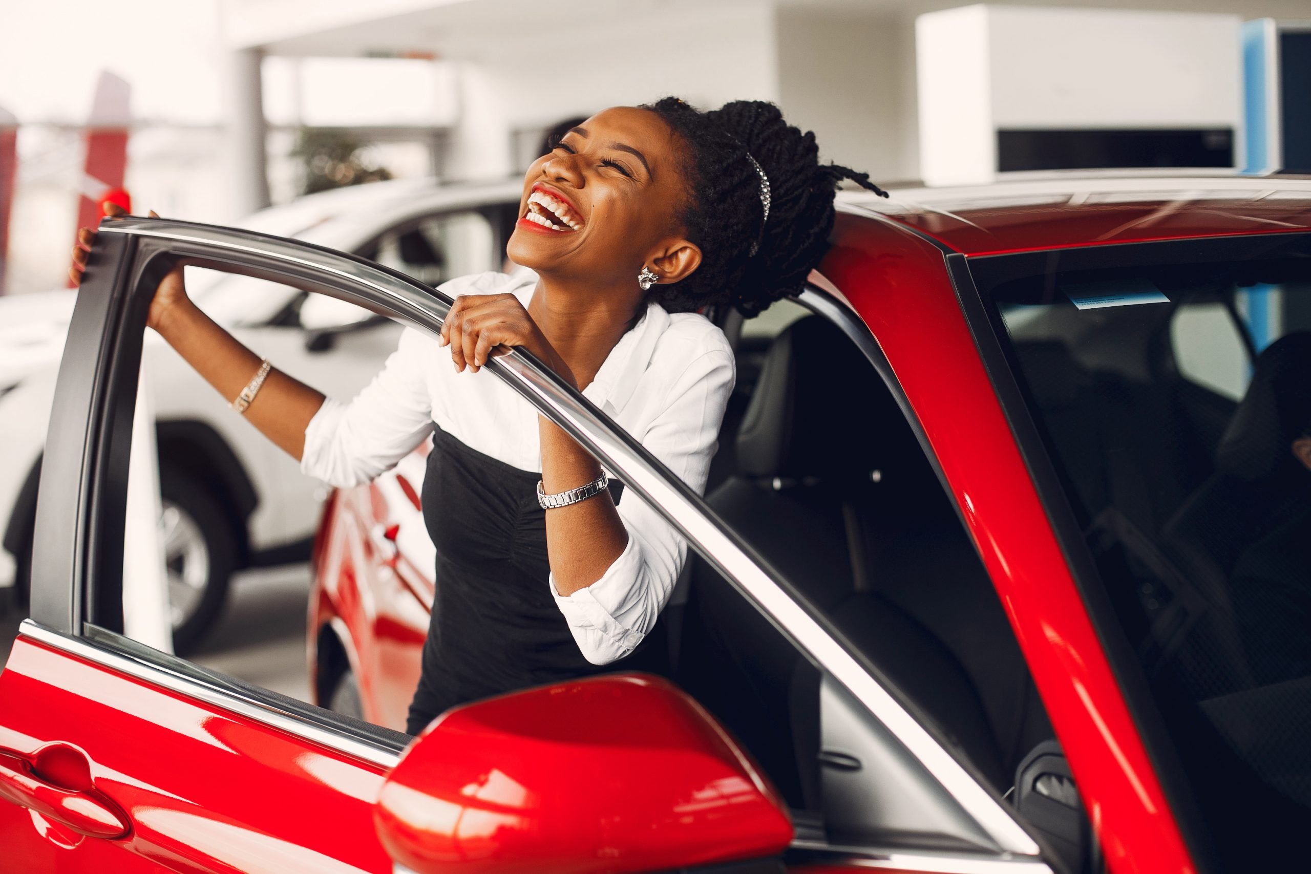 Happy woman who has just purchased a car