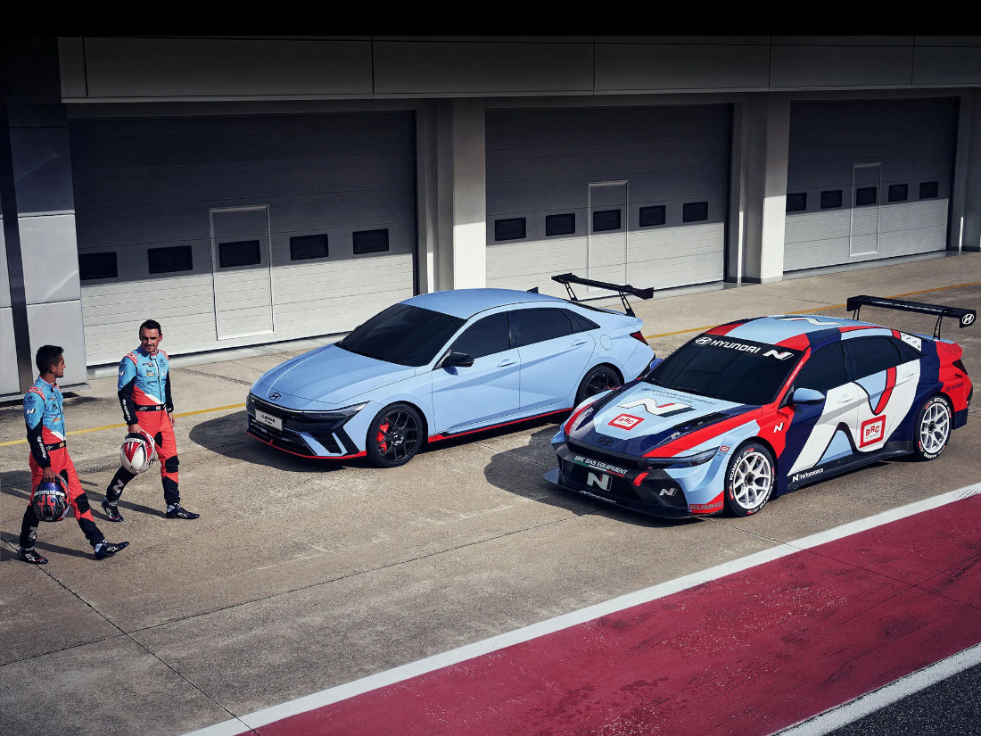 Two drivers approach two versions of the Elantra N TCR on a racetrack