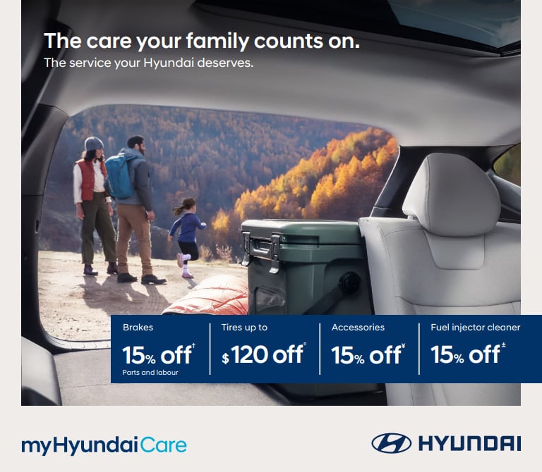A family preparing for a fall hike seen through the open liftgate of a Hyundai SUV. Text: The care your family counts on. The service your Hyundai deserves.