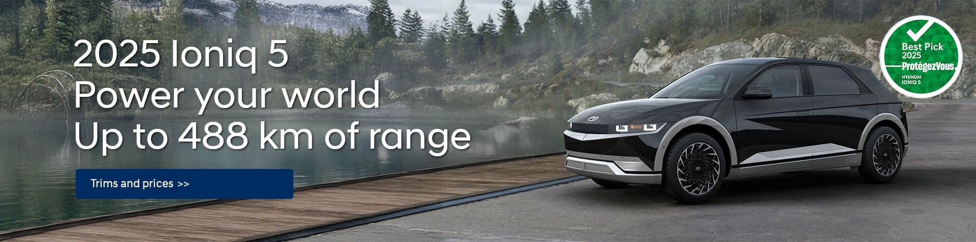 A black 2025 Hyundai Ioniq 5 is parked on the shore of a lake.