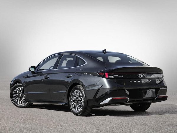 Three-quarter rear view of the 2026 Hyundai Sonata Hybrid Preferred Trend — full-width LED bar.