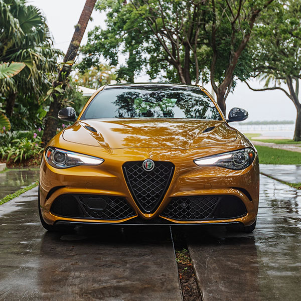 Alfa Romeo Giulia parked on a wet driveway.